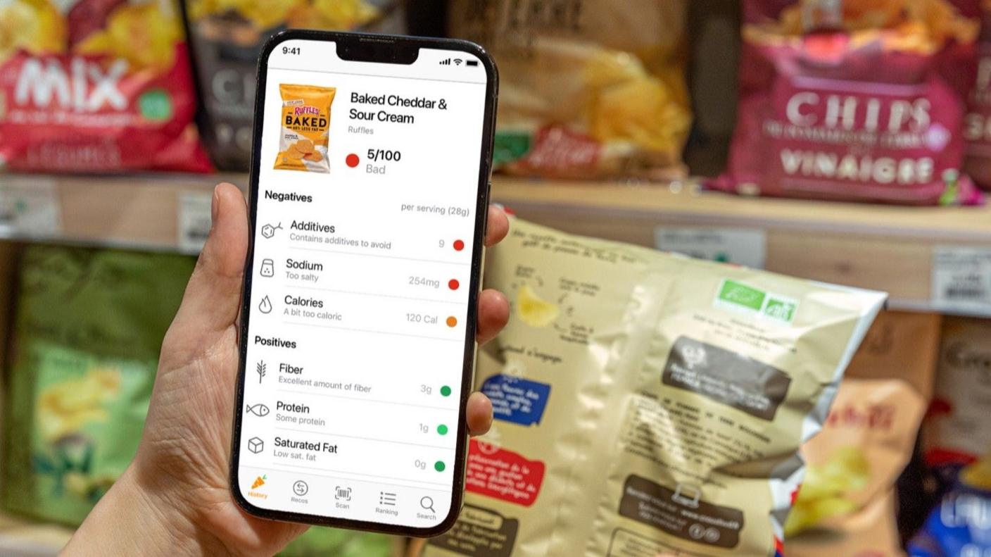 Someone scans a bag of crisps using the Yuka app