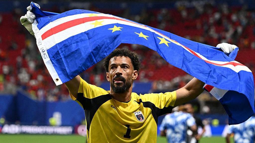Vozinha holding Cape Verde flag