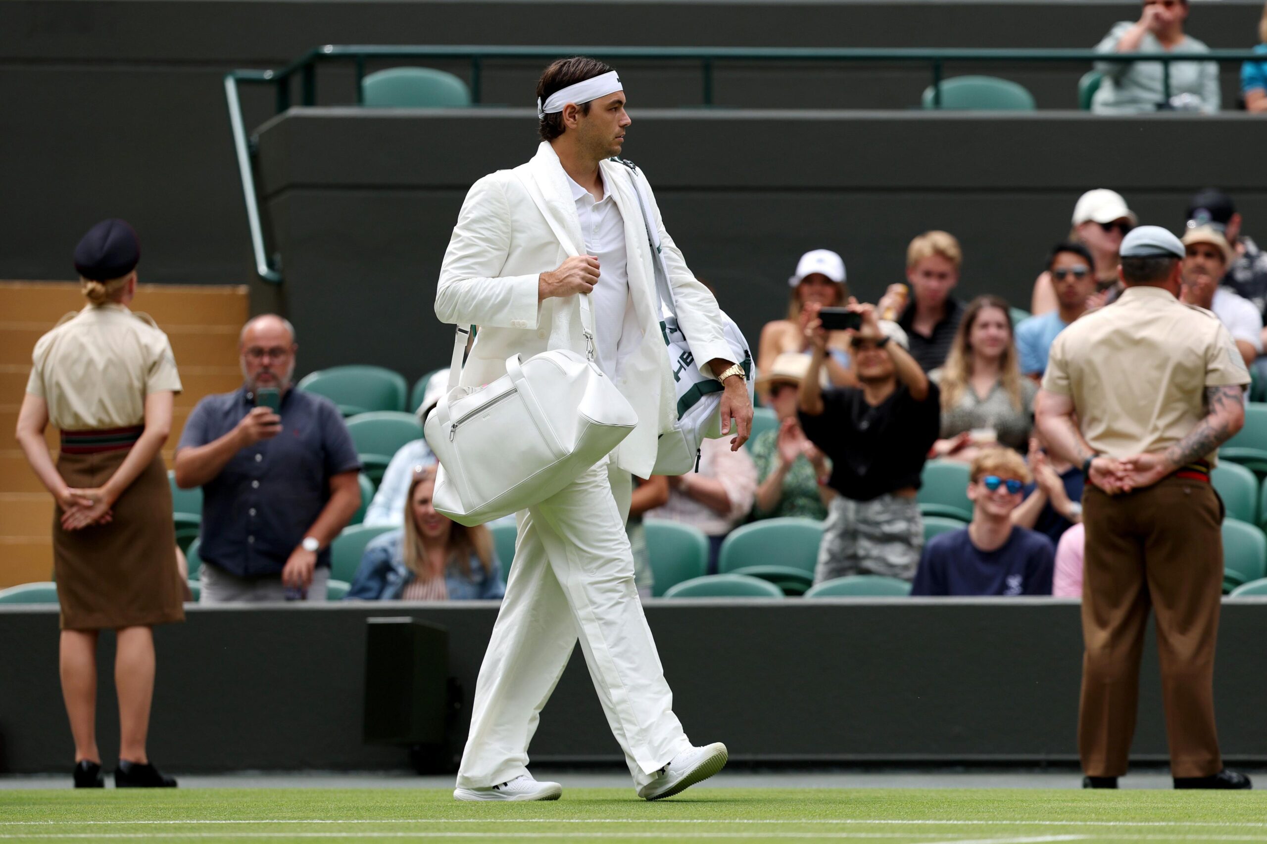 Taylor Fritz walks out in white suit for his first round match at Wimbledon