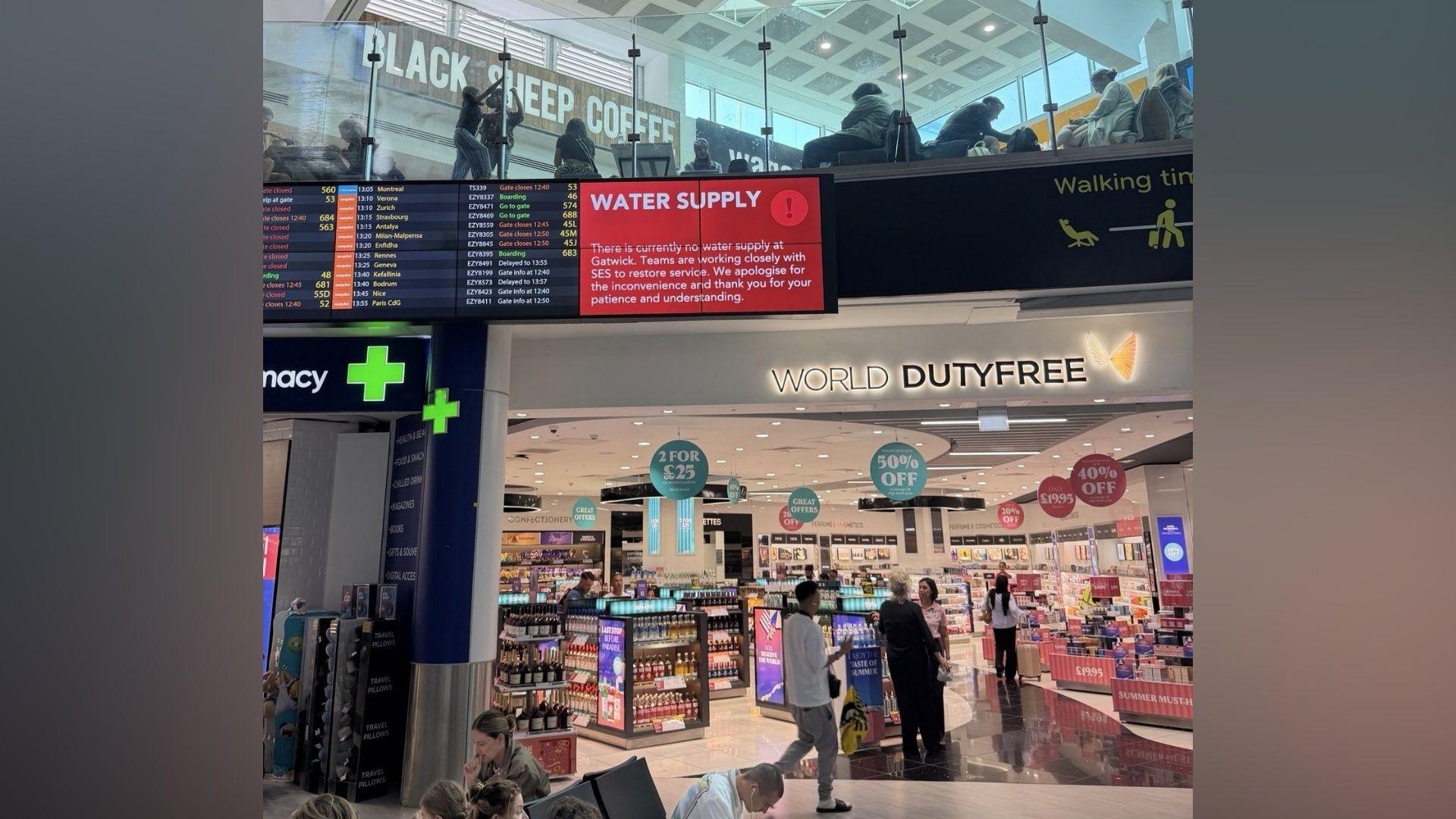 A red sign at Gatwick Airport which says "Water Supply" on it.