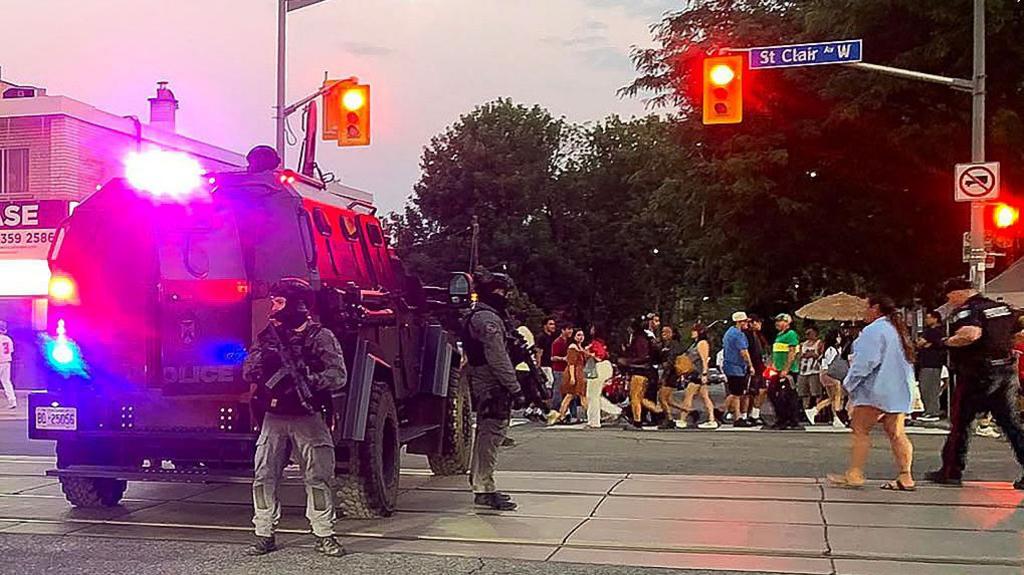 Emergency Task Force vehicles and police officers are seen on the site of a shooting in Toronto, Canada on July 11, 2026.