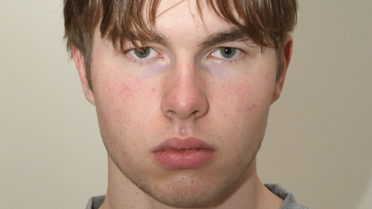 A mugshot of a young man staring at the camera.