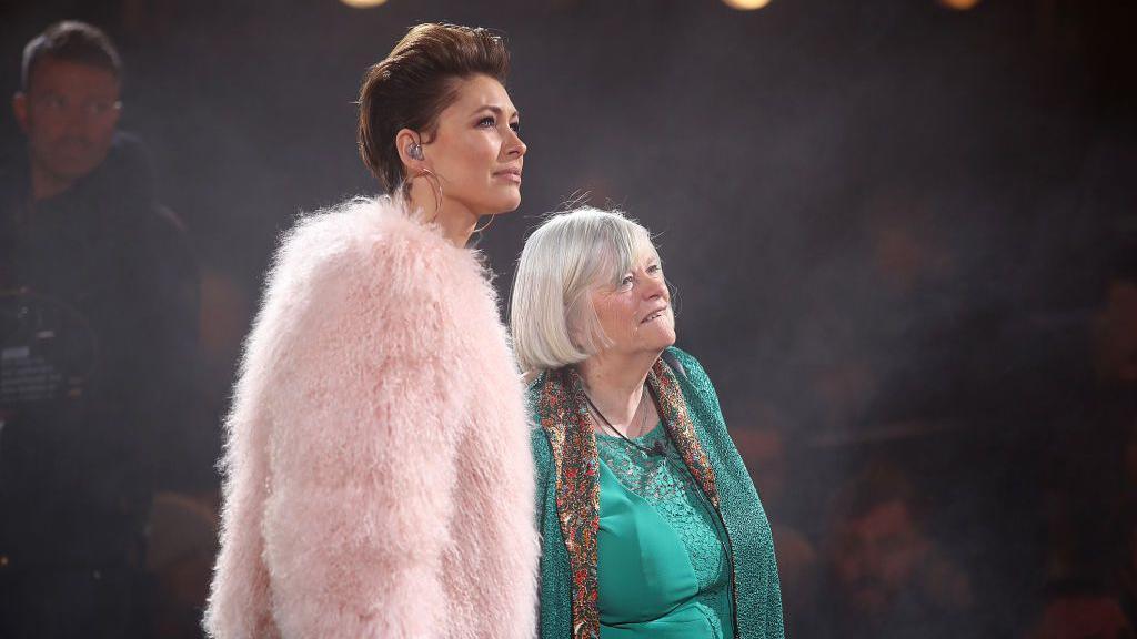 Widdecombe on stage after Big Brother. She is wearing a turqoise dress and shawl.