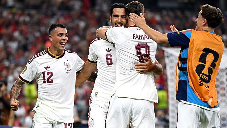 Mikel Merino #6 of Spain celebrates with team-mates after scoring his team's first goal