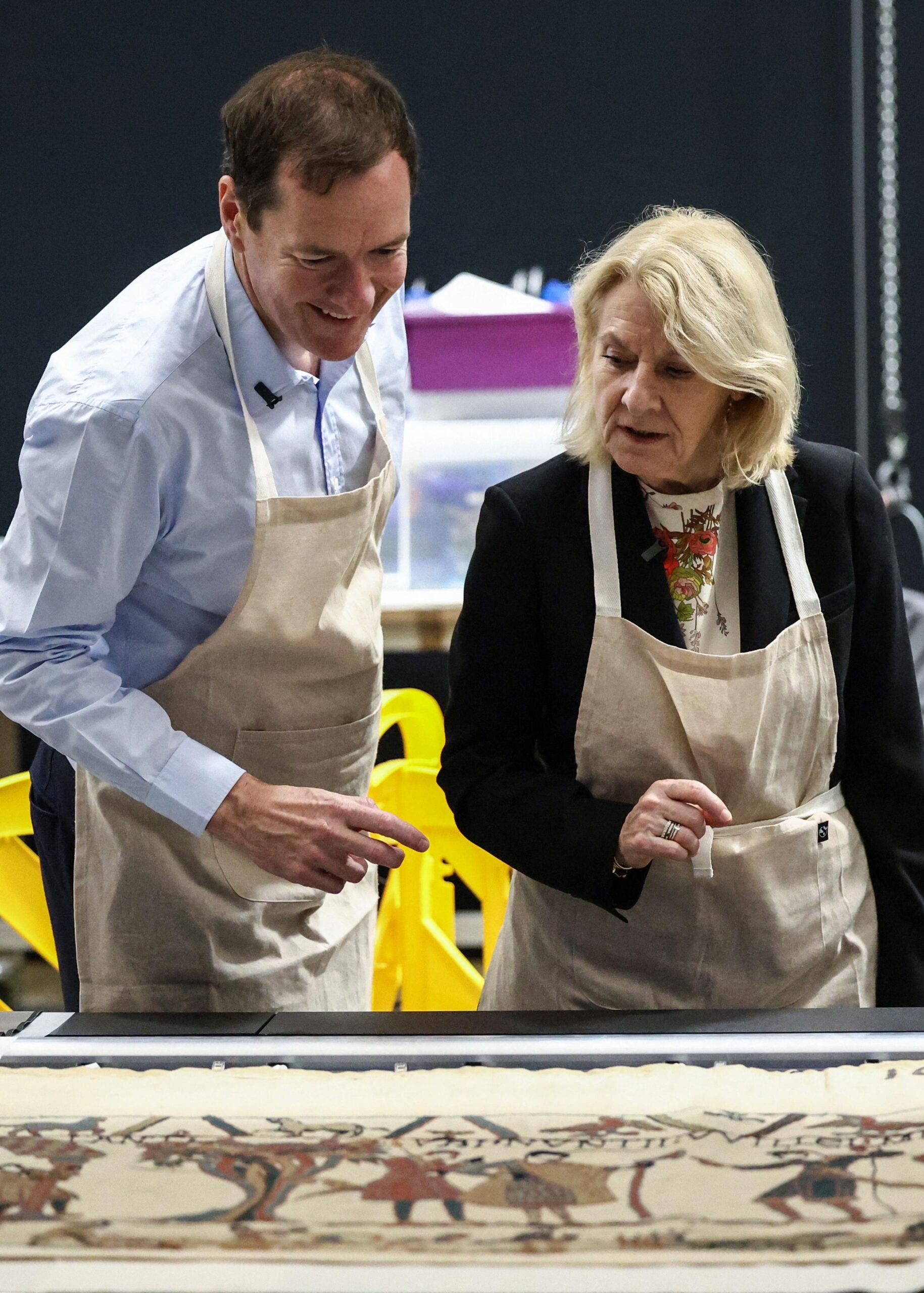 British Museum chair, George Osborne  looking at a section of the Bayeux Tapestry, along with the French Culture Minister, Catherine Pégard  Tapestry is laid out on the table