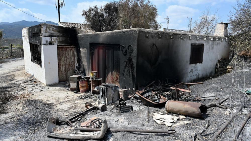 Burnt land next to Anita's restaurant after Los Gallados fire in Beda village, Almeria, southern Spain