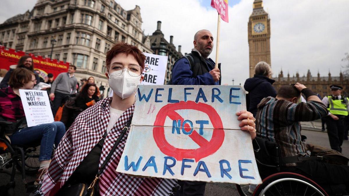Protesters demonstrate against disability and welfare cuts during the announcement of the Spring Statement outside parliament in London, Britain, 26 March 2025.