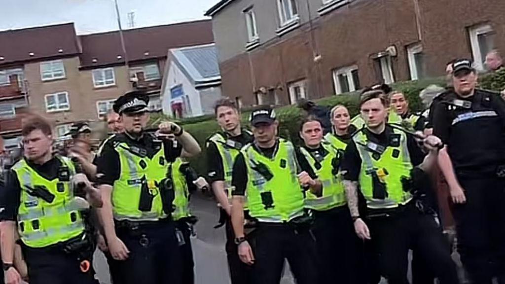 Officers in hi-vis gear standing on a street in Glasgow.