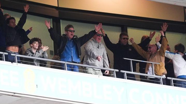 Noel and Liam Gallagher celebrating Manchester City's FA Cup final win at Wembley Stadium, with a little help from their friends