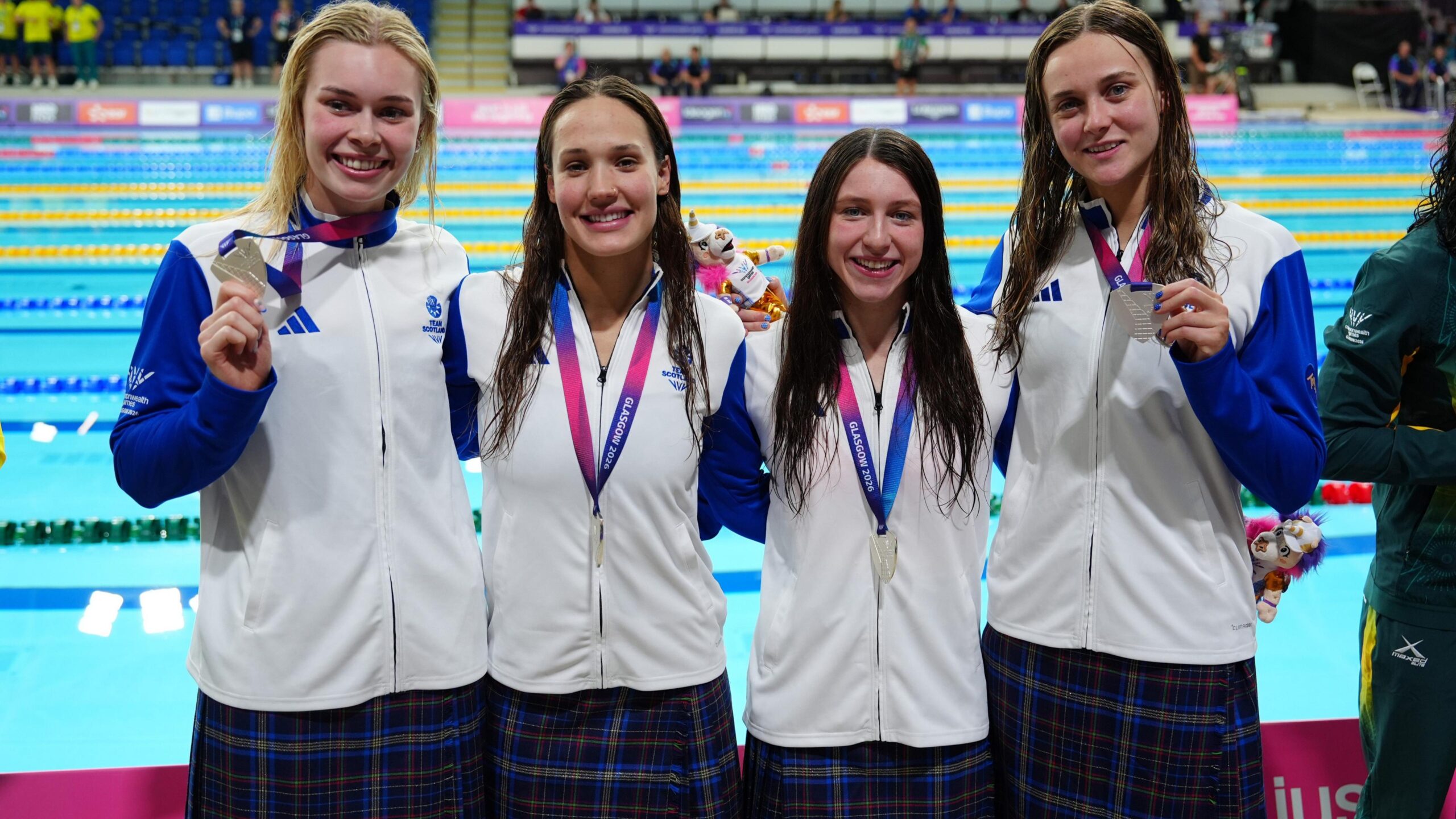 Commonwealth Games 2026 - Swimming - Tollcross International Swimming Centre, Glasgow, Scotland, Britain - July 29, 2026 Silver medallists Scotland's Katie Shanahan, Angharad Evans, Keanna Macinnes and Evelyn Davis celebrate on the podium after the women's 4 x 100m medley