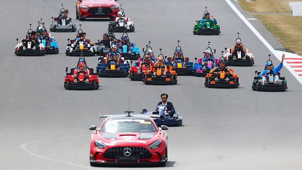 The F1 drivers driving around in Lego karts at the Silverstone circuit during the driver parade. They are joined by FIA president Mohammed Ben Sulayem.