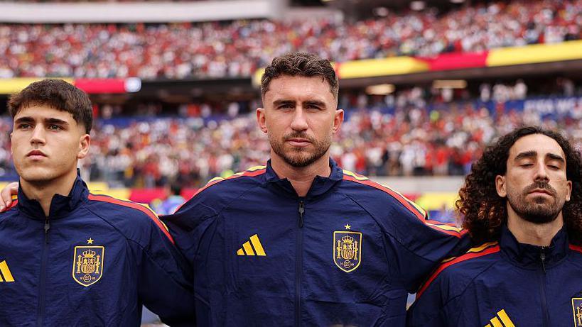 Spain defenders Pau Cubarsi, Aymeric Laporte and Marc Cucurella stand side by side during the national anthem before the World Cup match against Austria