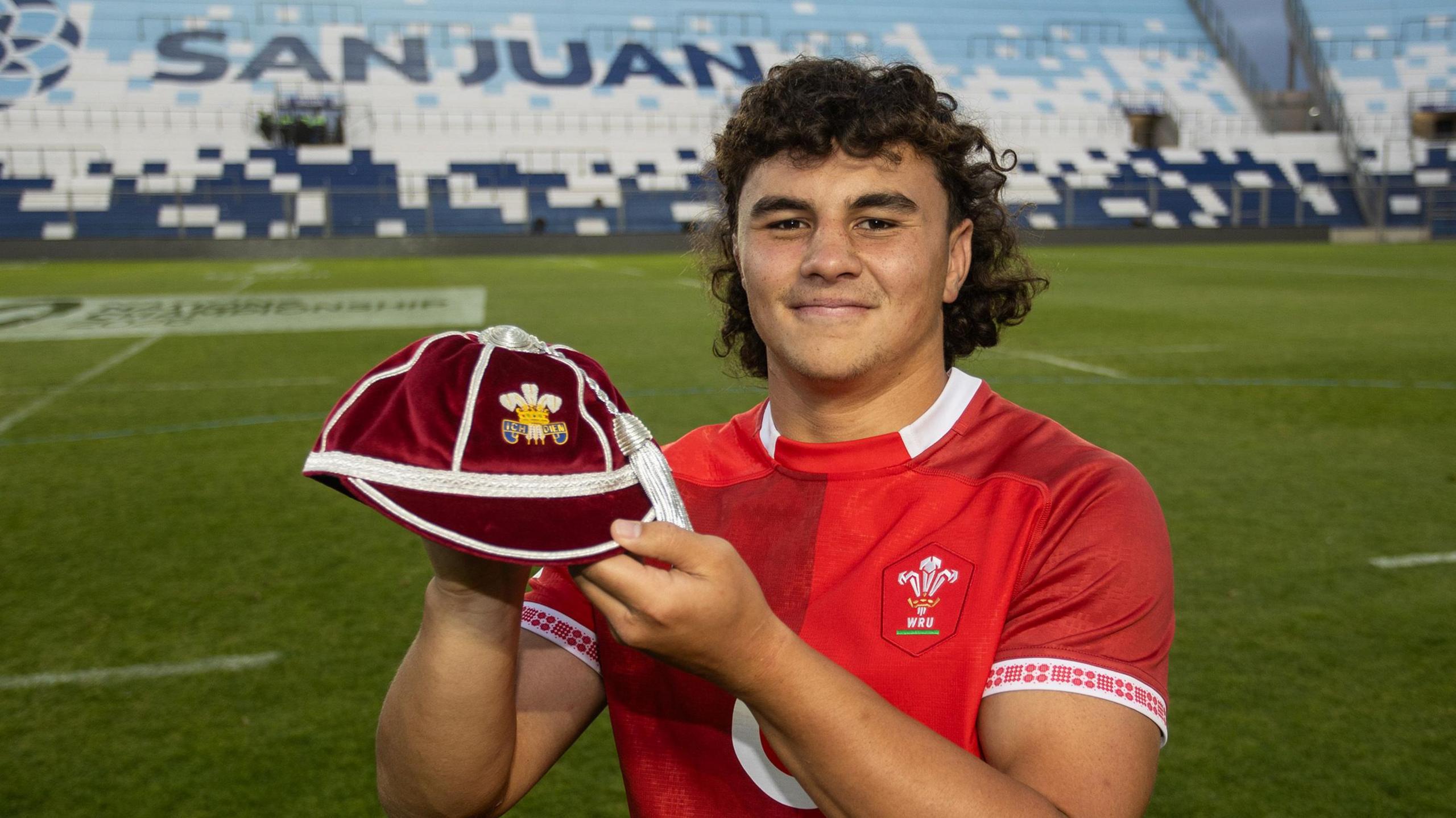 Kane James holds up his first Wales cap in San Juan, Argentina