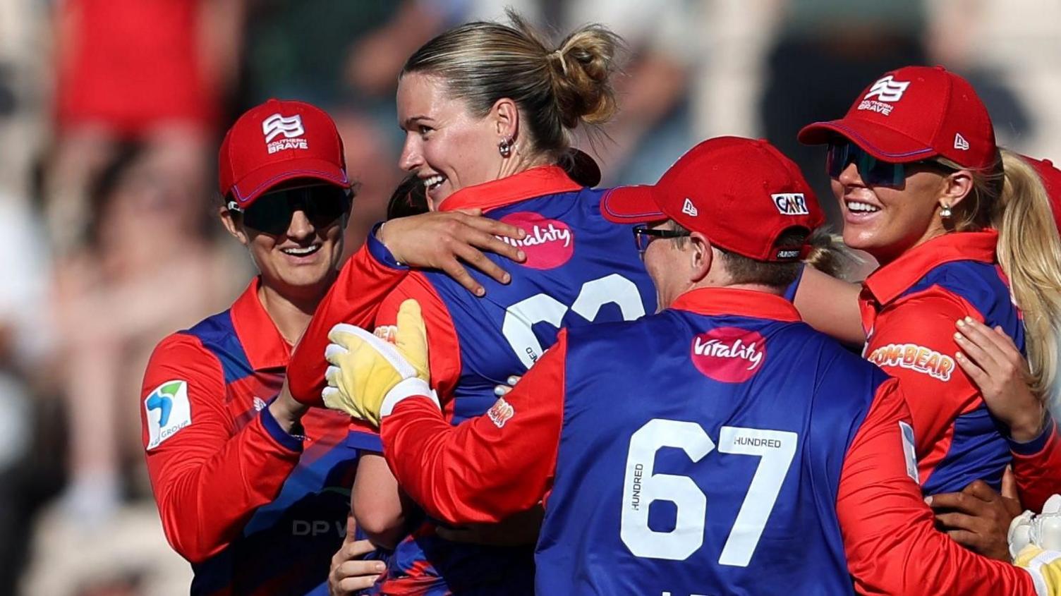 Lauren Bell is mobbed by her Southern Brave team-mates at the conclusion of their win over MI London in The Hundred