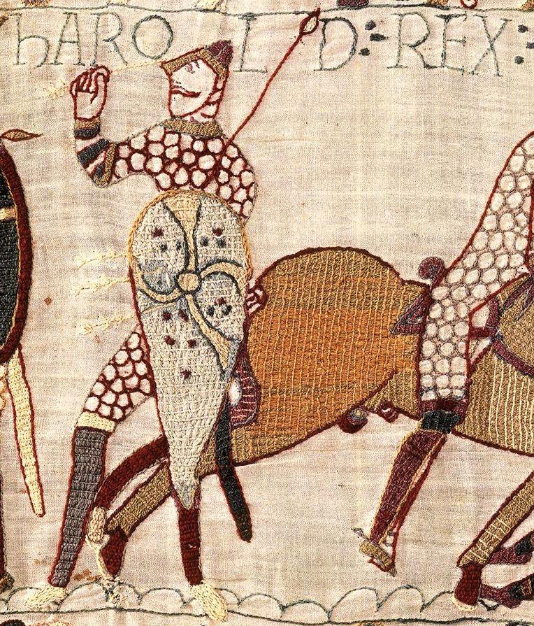 A close crop shows Harold depicted as being shot with an arrow next to a horse, with writing reading 'Harold rex' with fabric detail.