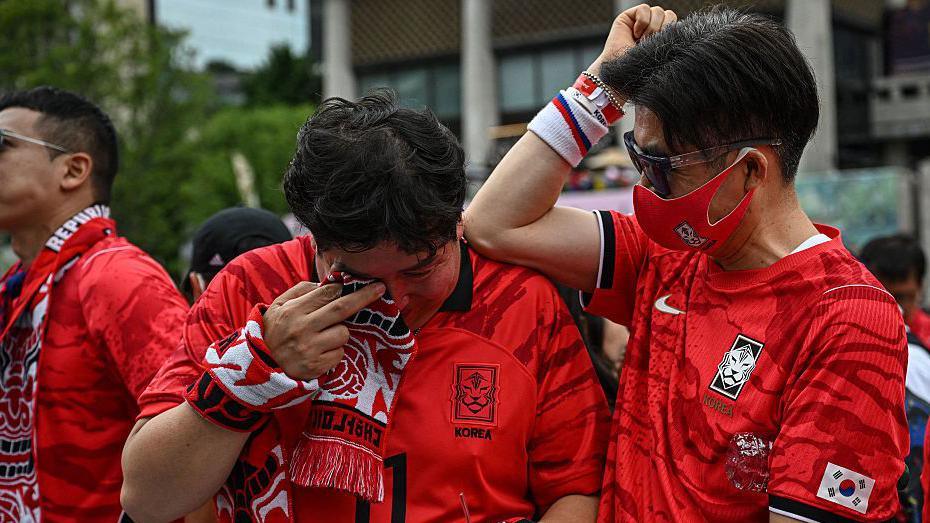 South Korean fans react after their team lost the 2026 World Cup football match against South Africa at Gwanghwamun Square in Seoul on June 25, 2026.