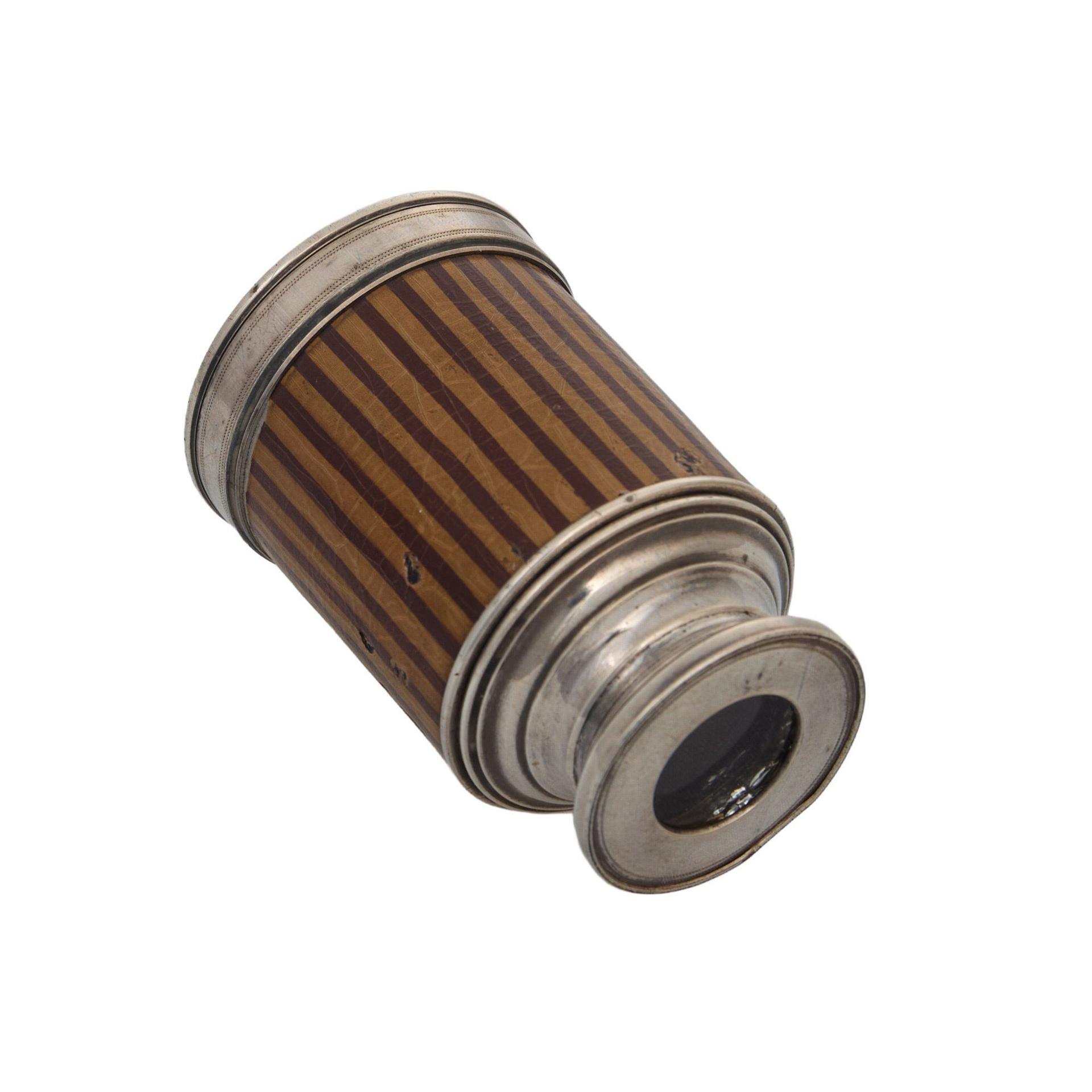 A silver spy glass.