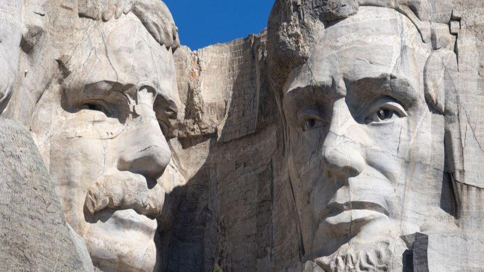 The faces of Teddy Roosevelt and Abraham Lincoln on Mount Rushmore