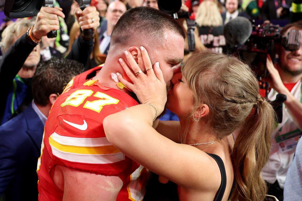Travis Kelce #87 of the Kansas City Chiefs kisses Taylor Swift after defeating the San Francisco 49ers 25-22 in overtime during Super Bowl LVIII at Allegiant Stadium on February 11, 2024 in Las Vegas, Nevada