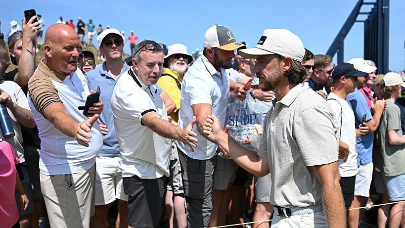 Tommy Fleetwood fist-bumps the Birkdale crowd