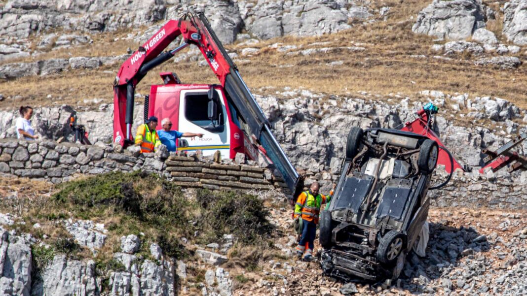 Car flips and plunges off steep cliff after driver seen ploughing through walls and fences Car flips and plunges off steep cliff after driver seen ploughing through walls and fences