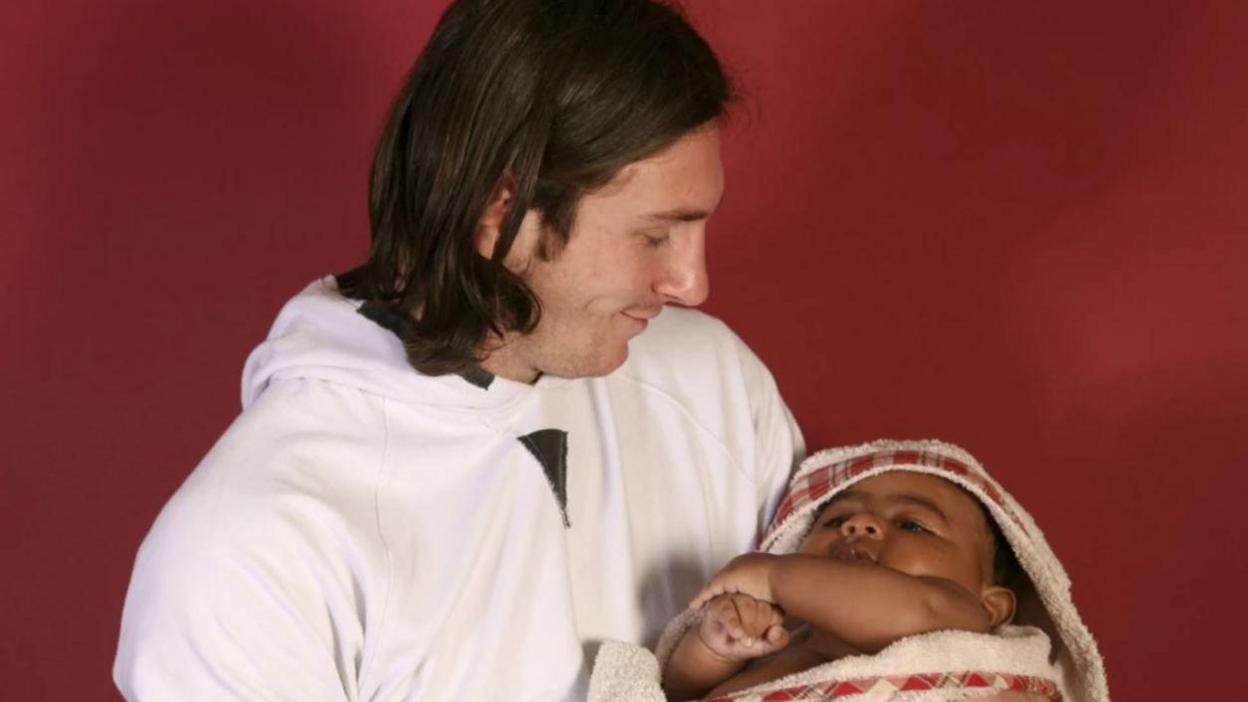 Lionel Messi cradles a baby Lamine Yamal in a bath in the away dressing room at Barcelona's Camp Nou stadium in 2007