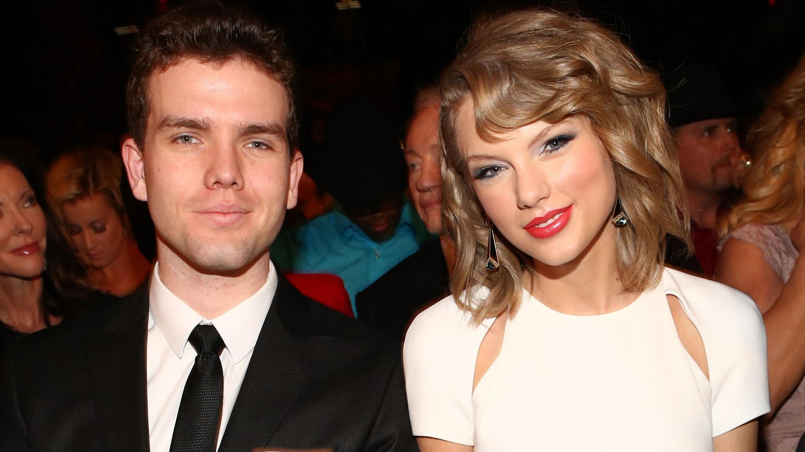 Austin and Taylor Swift sitting together and smiling at the Annual Academy of Country Music Awards in 2014 in Las Vegas