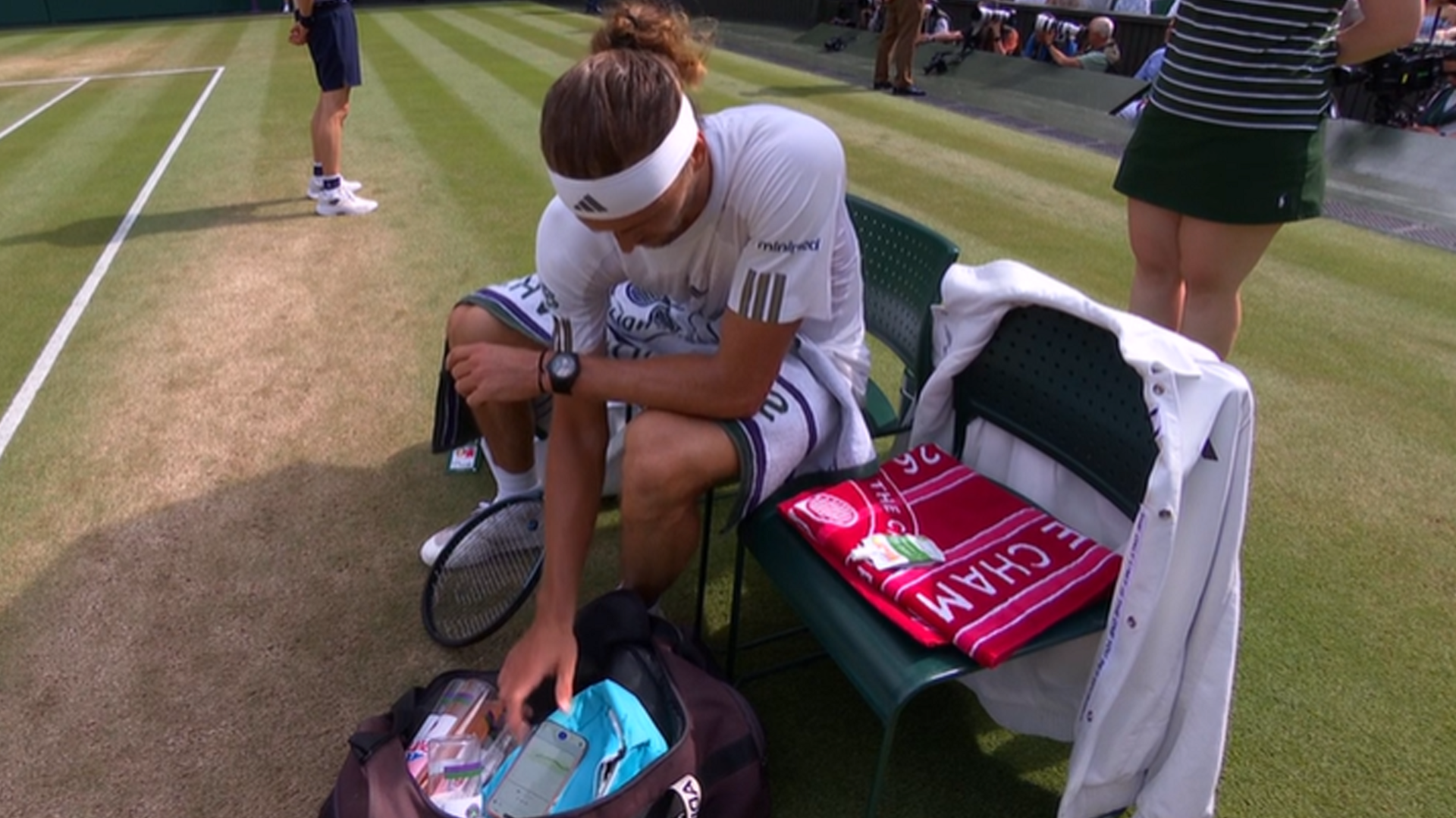 Alexander Zverev checks his glucose levels on his phone during a match at Wimbledon