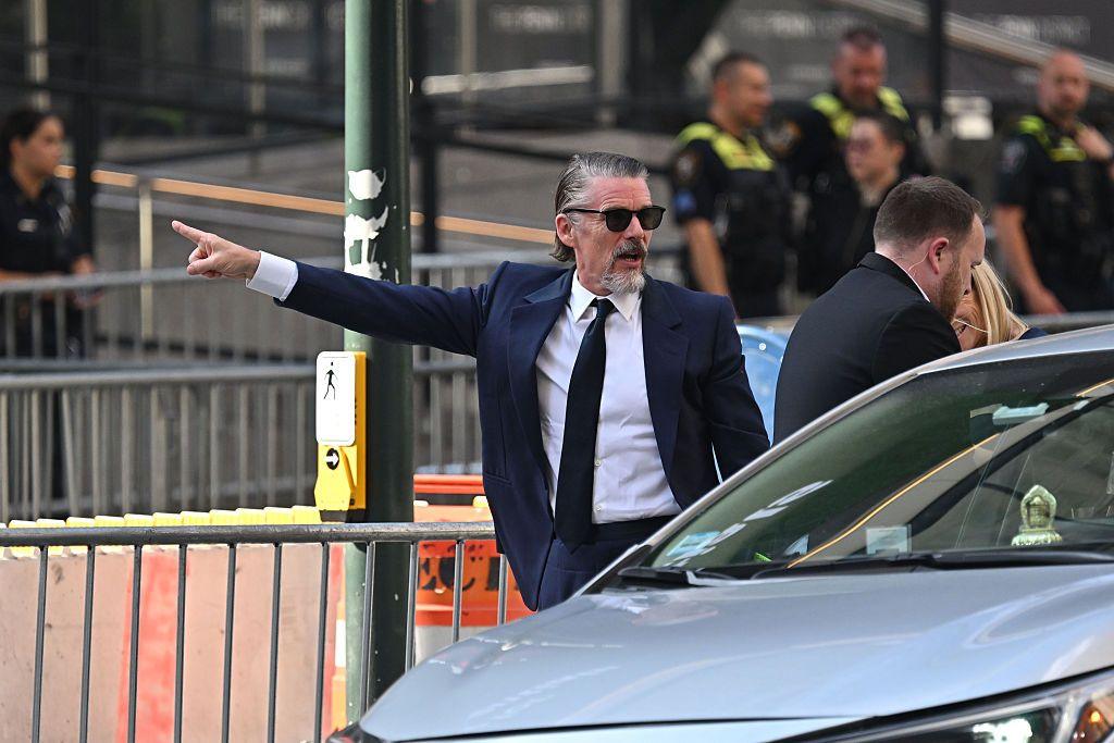 Ethan Hawke points his arm as he arrives at Madison Square Garden on 3 July.