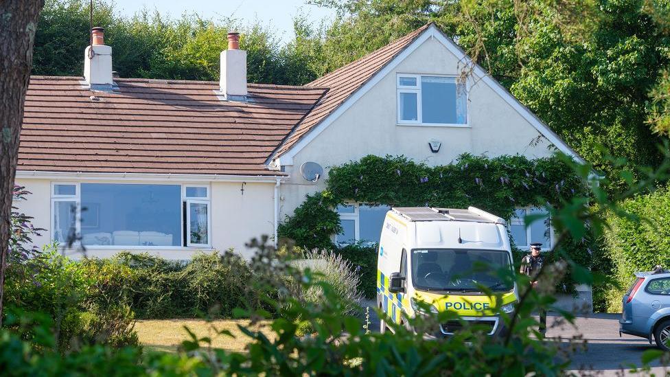 Police outside the house of Ann Widdecombe in Haytor in Dartmoor. A police van parked on the driveway