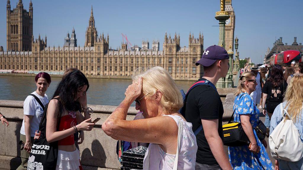 People walking along the South Bank in London, during June's extreme heatwave