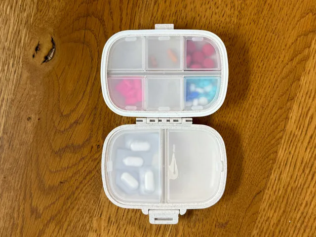Pill case with six small sections and two large sections