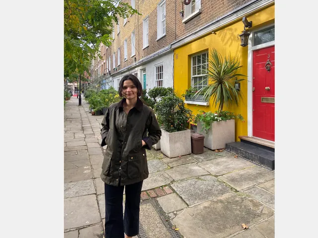Image may contain: Clothing, Coat, Path, Walkway, Jacket, Slate, Flagstone, Person, Road, Plant, Pants, and Cobblestone