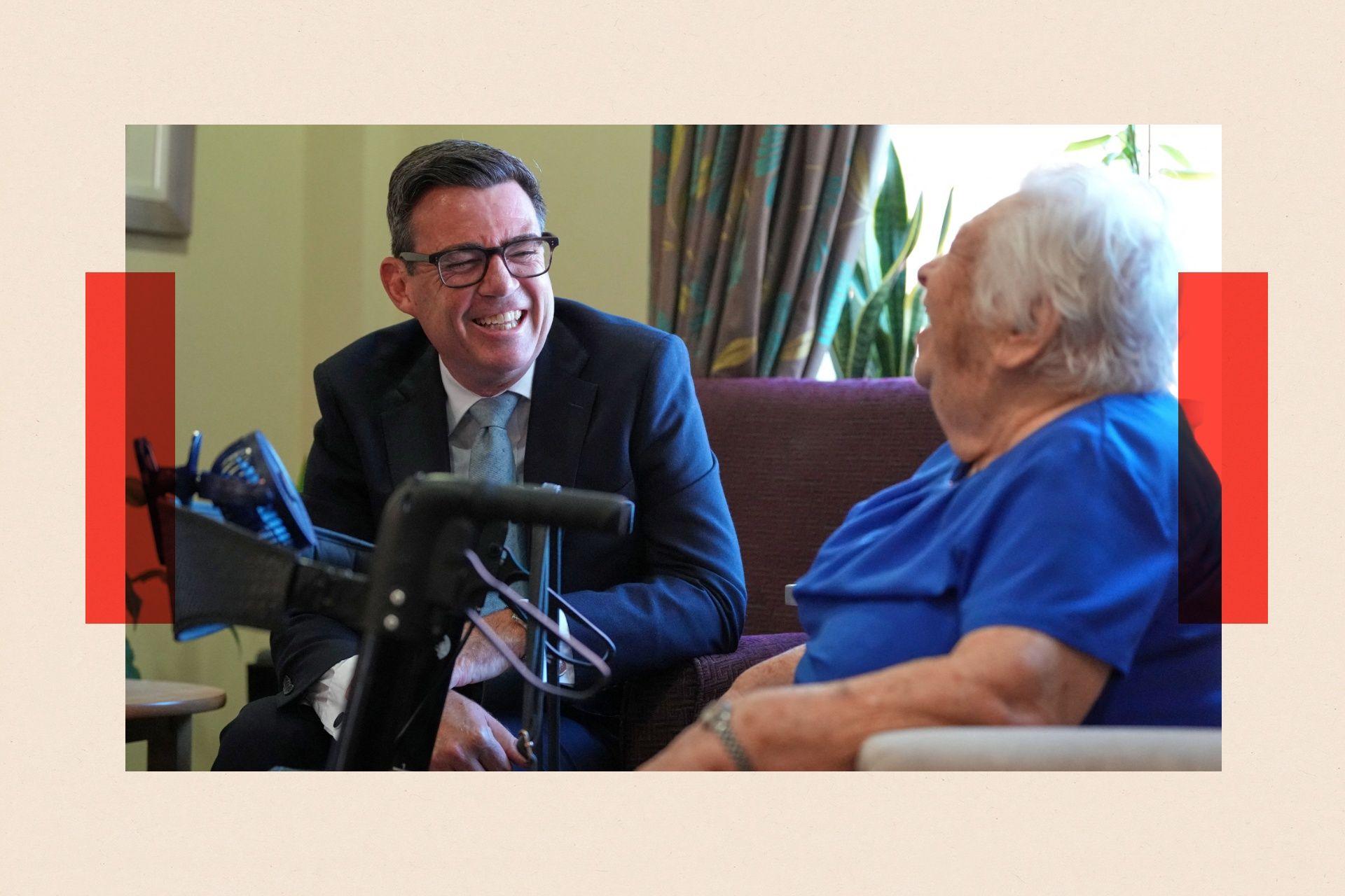 Britain's Prime Minister Andy Burnham talks to a resident during a visit to a care home in London