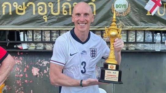 Footballer Kevin Ellison with the trophy after helping England win the 2026 Seniors World Cup
