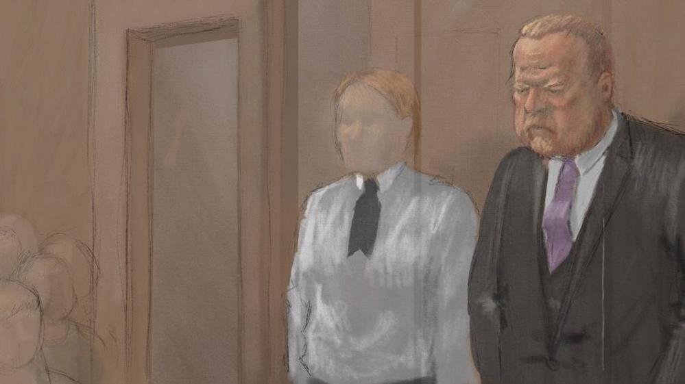An artist impression of the inside of court room 4 at Hull Crown Court. Robert Bush stands to the right wearing a formal suit and tie. A prison guard stands next to him wearing a white shirt.