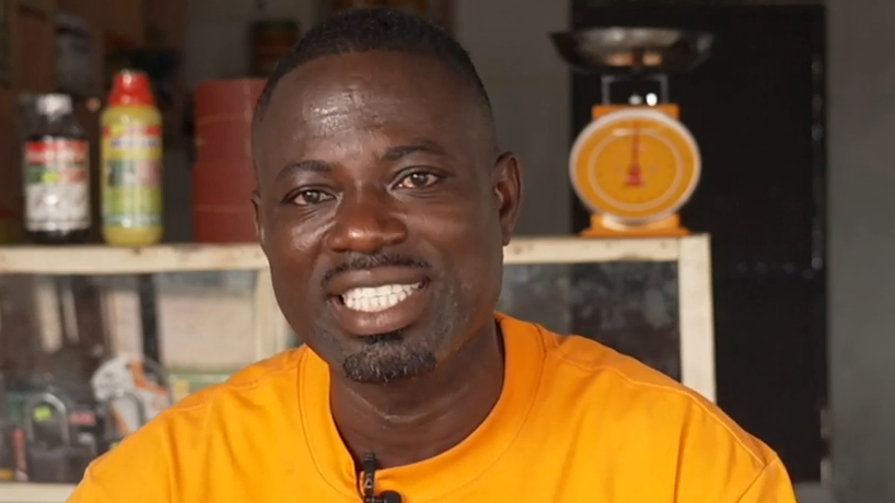 A head and shoulders image of Emmanuel Asamoah. He is smiling and wearing a bright yellow top.