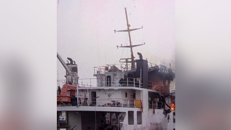 An image verified by the BBC reportedly showing the vessel which has been hit - fire can be seen billowing from the back of the ship, which is a small cargo vessel