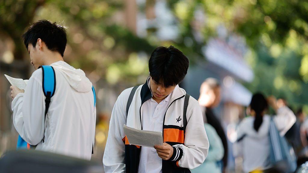 Students make last-minute reviews before entering the examination venue for the 2026 China's National College Entrance Exam on June 7, 2026 in Beijing, China.