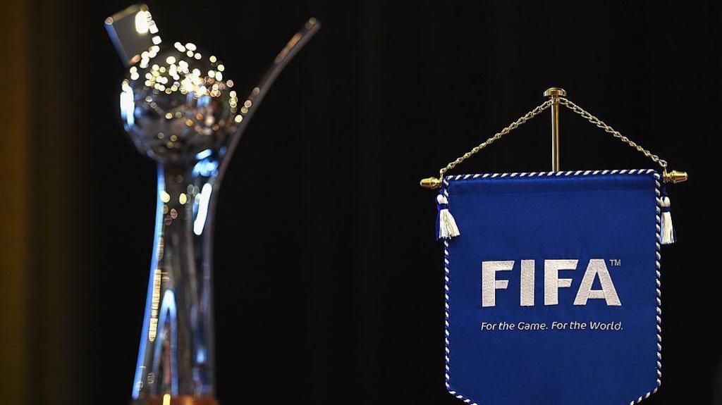 The Women's Under-20 World Cup trophy with a Fifa pendant in the background.