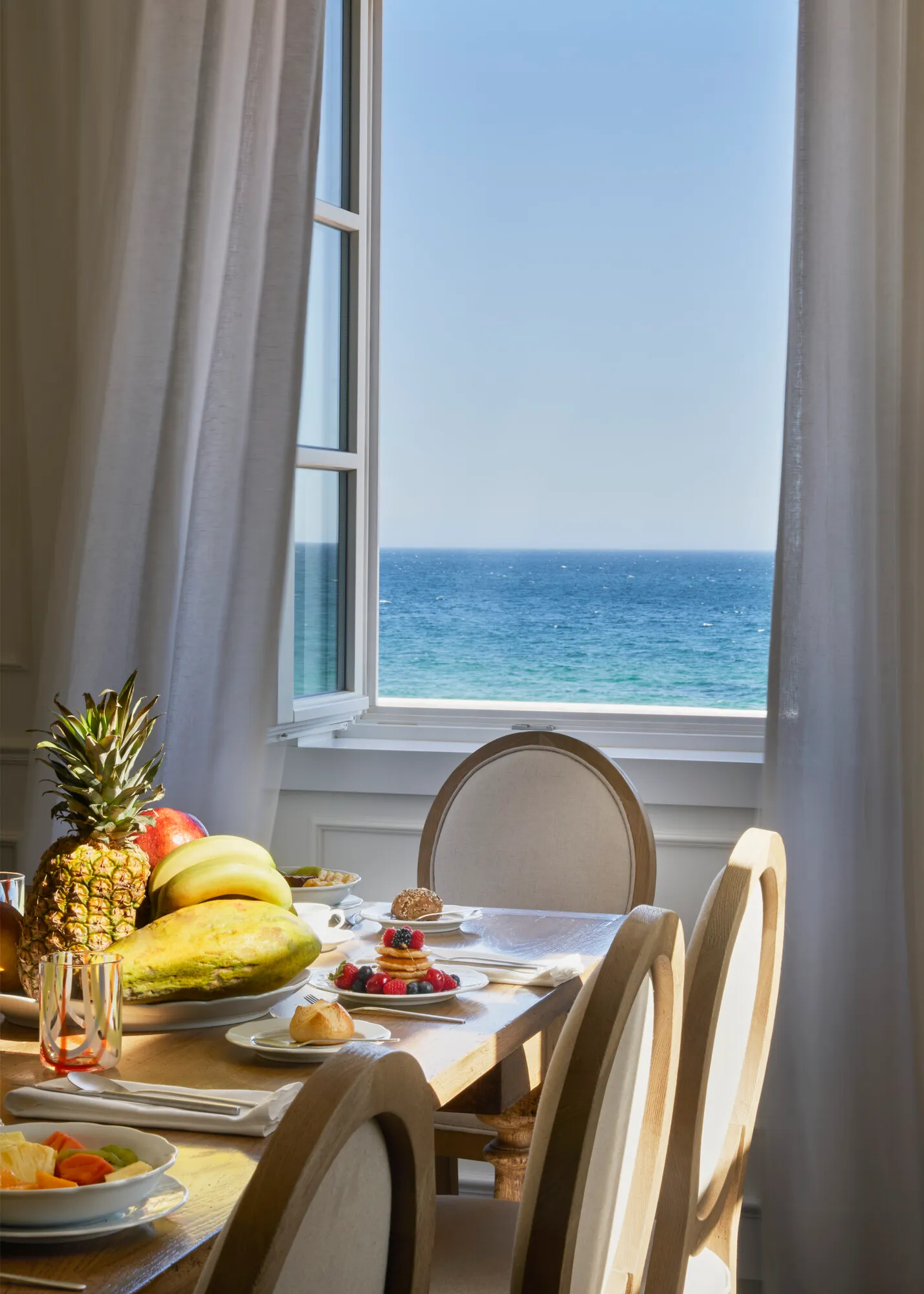 Image may contain Brunch Food Banana Fruit Plant Produce Pineapple Window Chair Furniture and Bread