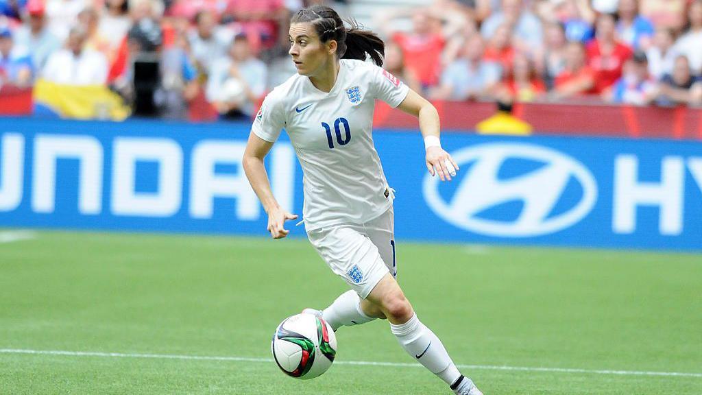 Karen Carney on the ball in white England kit at the 2015 Women's World Cup