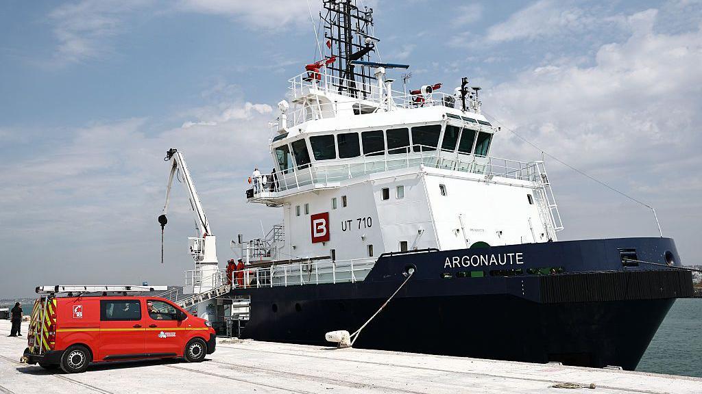 Boat pictured in dock as migrants disembark from the ship