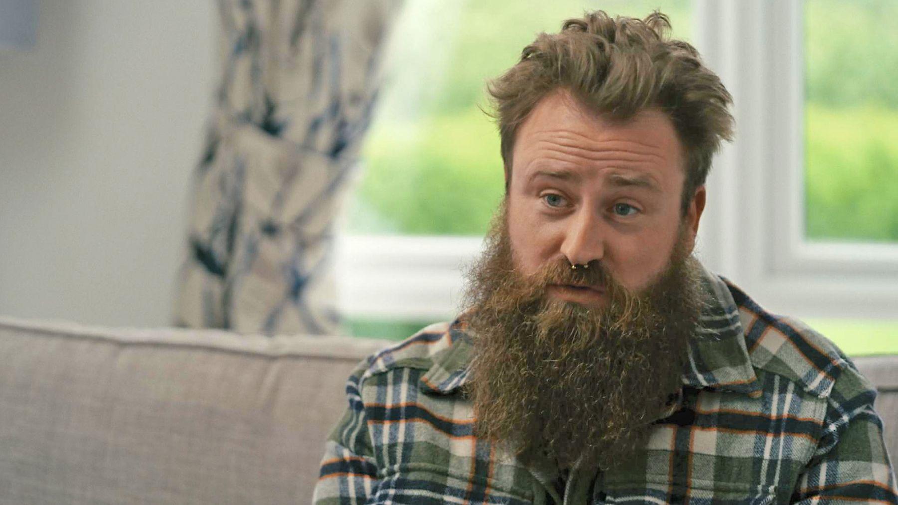 Ieuan Horgan, who has a long beard and nose ring and wears a checked lumberjack shirt, speaks to the BBC.
