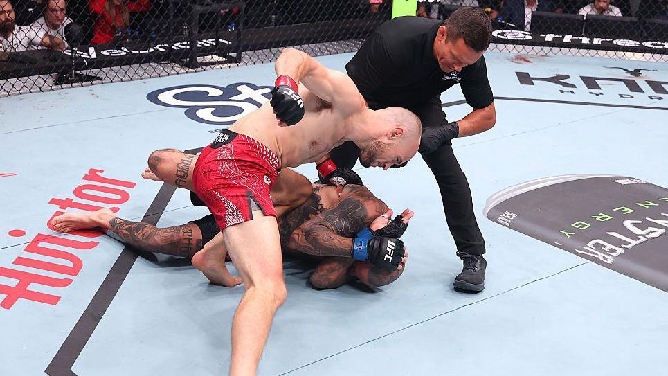 Uros Medic throws punches at Daniel Rodriguez, who covers up and lies on the canvas