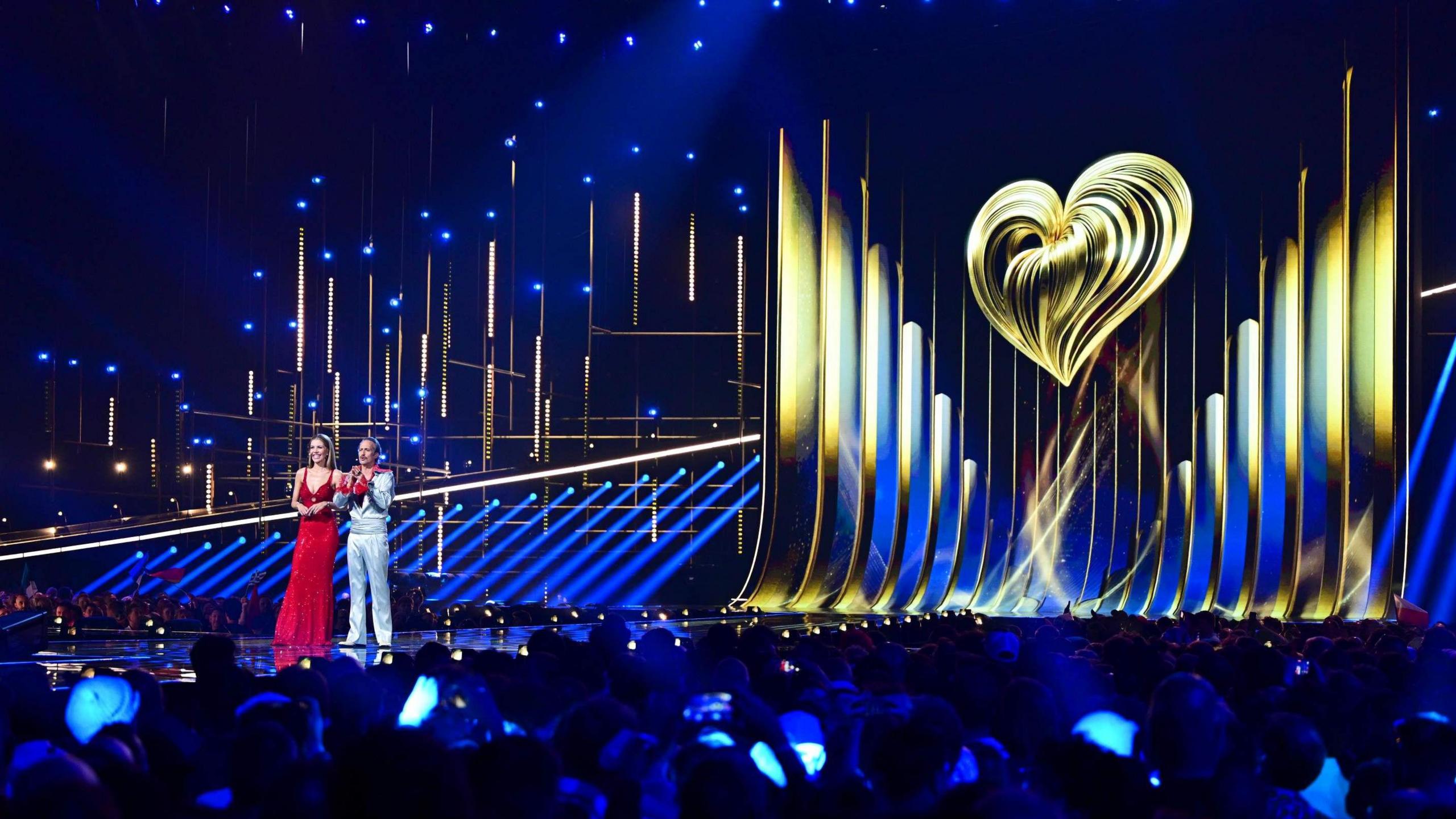 The Eurovision stage at the Vienna contest earlier this year, the two hosts are at the front with the Eurovision logo as the backdrop