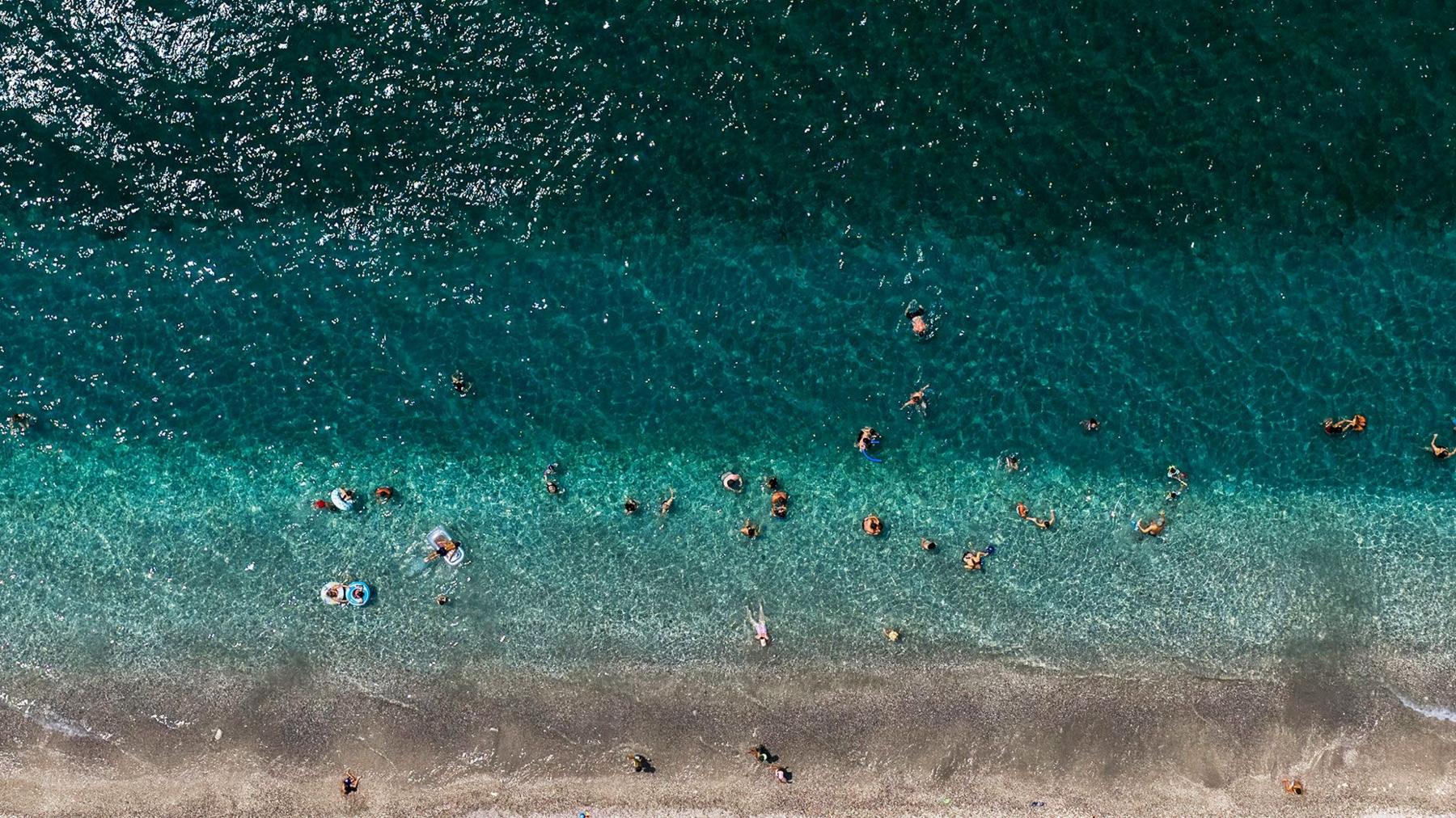 Aerial view of strip of beach in Greece and ocean