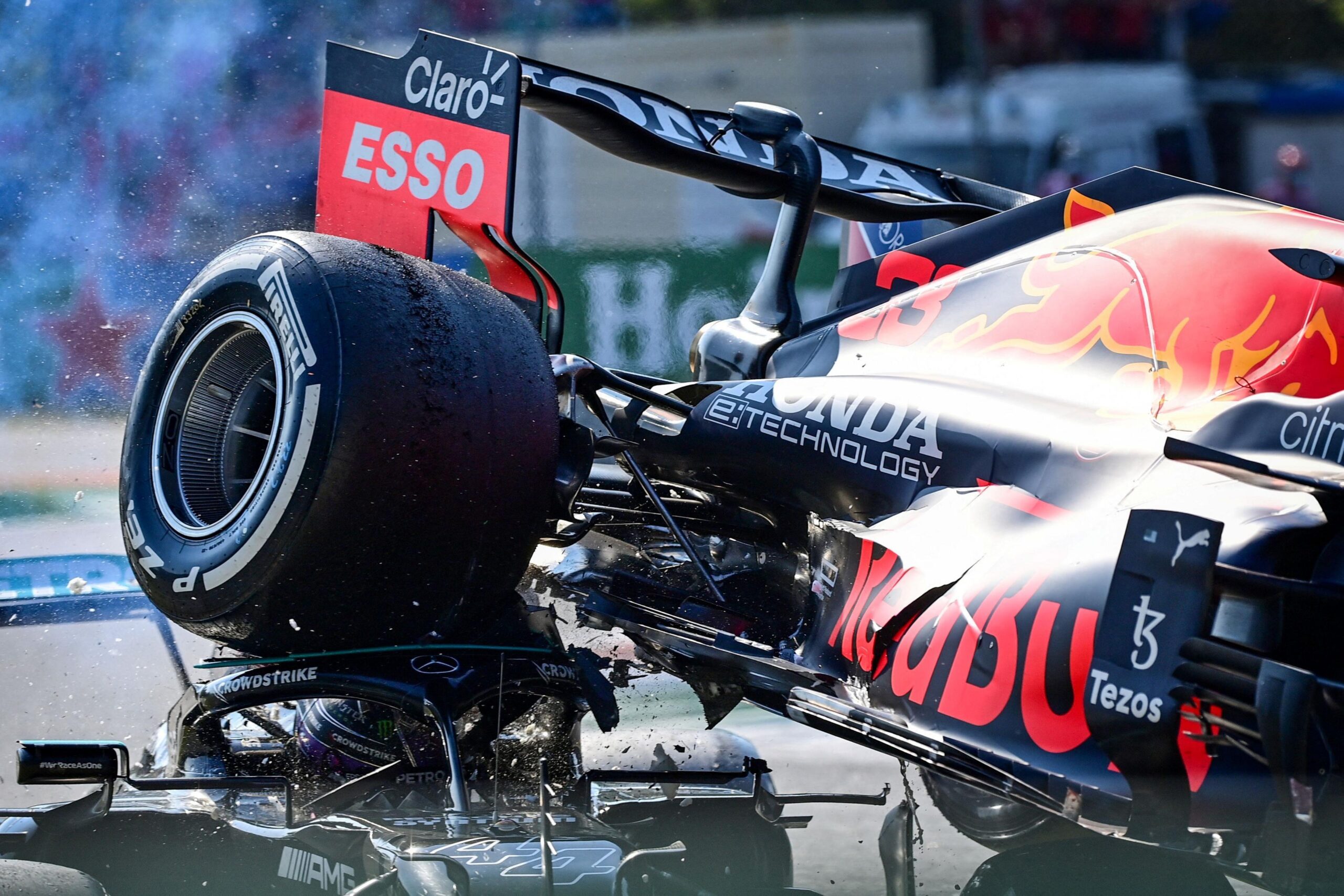 Theright rear tyre of Max Verstappen's Red Bull sits on top of the halo head protection device of Lewis Hamilton's Mercedes after their head collision at the 2021 Italian Grand Prix