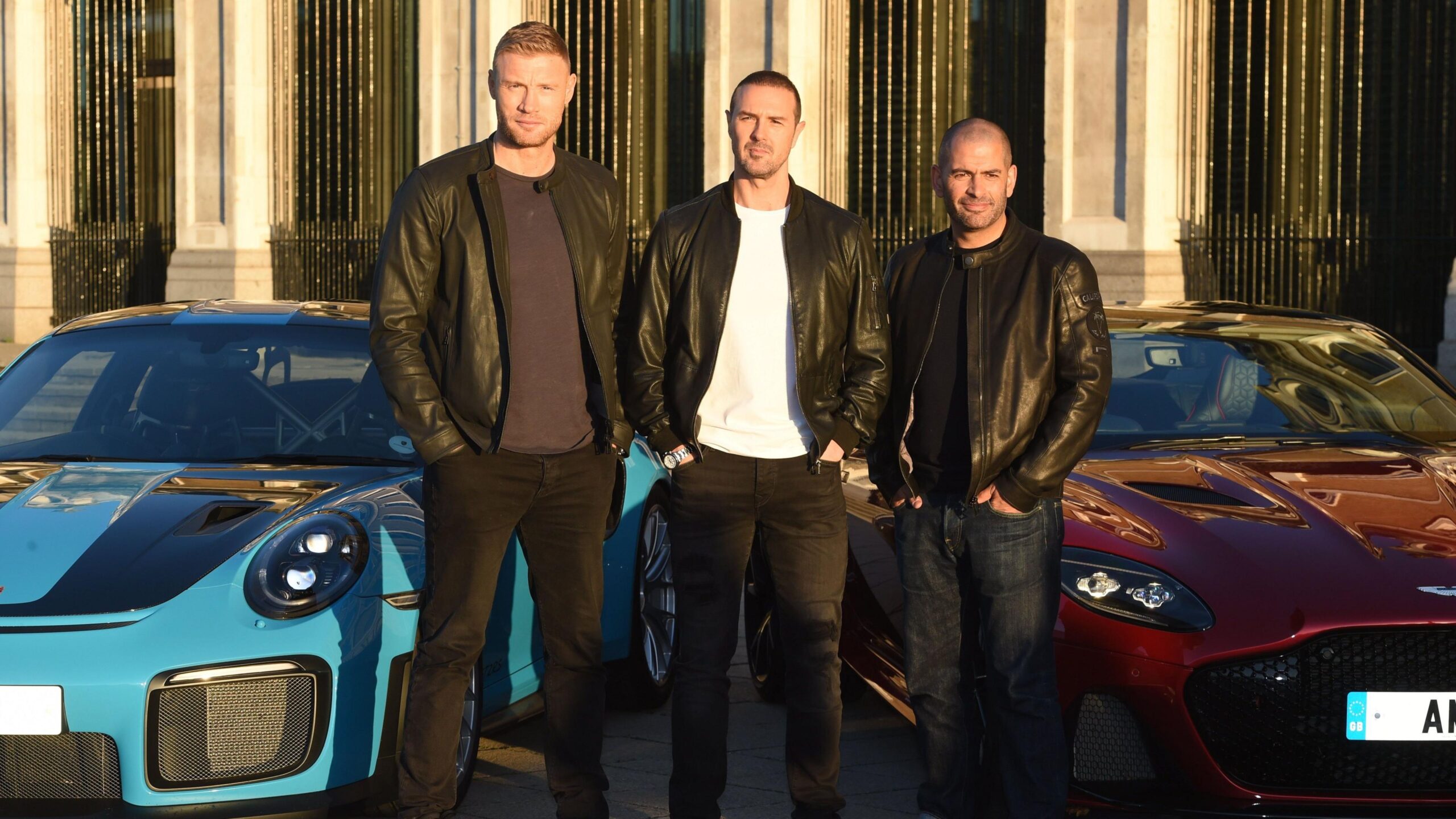 Andrew Flintoff, Paddy McGuinness and Chris Harris standing in front of two cars