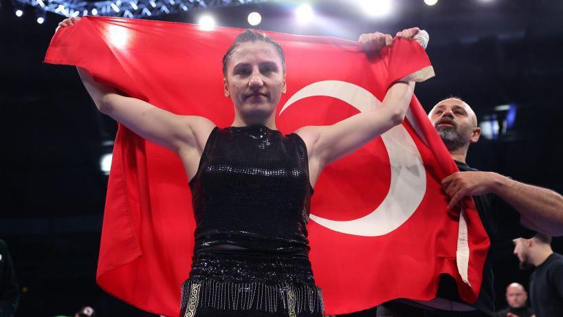 Elif Nur Turhan posing with the Turkish flag